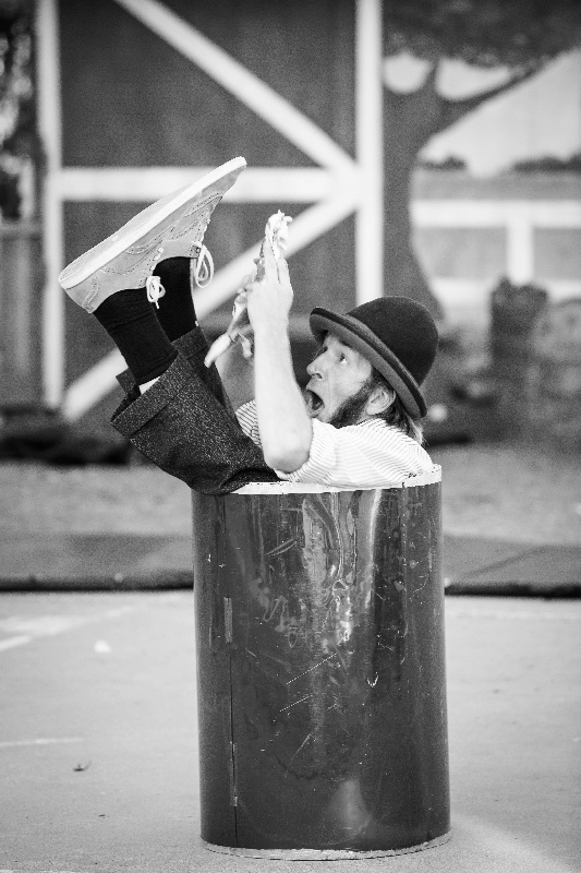 Slim in a barrel with a funny face in black and white