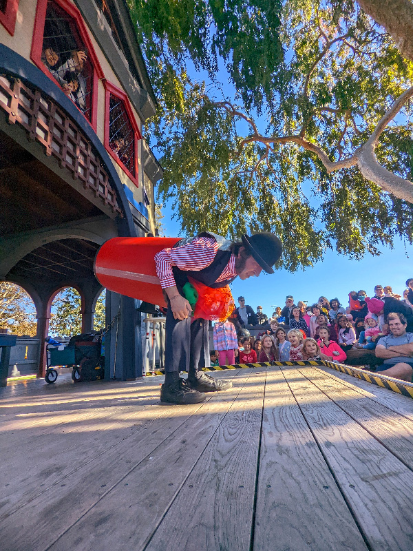 Slim in a colorful barrel in front of a family audience